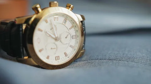 Minute and second hands move, rotate in a wristwatch with a strap lying on a Stock Footage 105344336