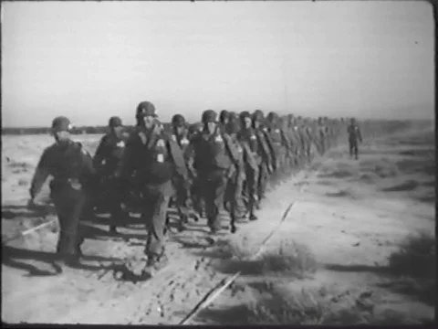Minutes after an atomic blast, troops walk into the radioactive cloud in the Stock Footage 74736131
