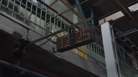 Minutes change on large pixel digital clock in dark old train station. Stock Footage 251707577