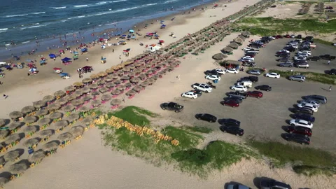 Miramar Beach parking area crowded with vehicles and beach visitors Stock Footage 342664119