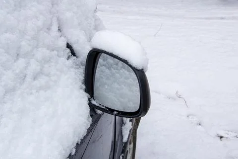 Mirror and windscreen of a car covered with snow 写真素材