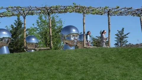 Mirror art object by sculptor Ken Kelleher 'Inner Child' in city park Krasnodar Stock Footage 153973872