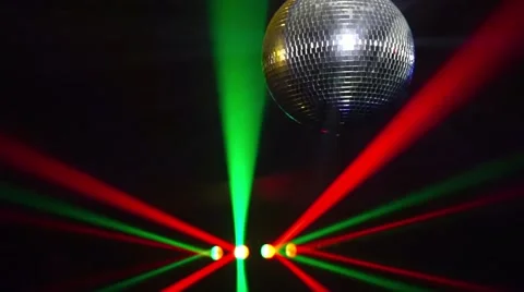 Mirror balls rotate and reflect lights of projectors breaking through smoke at Video stock 68080795