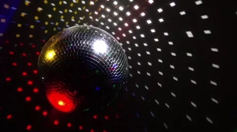 Mirror balls rotate and reflect lights of projectors breaking through smoke at Video stock 68290177