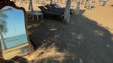 Mirror on beach reflecting empty swing and sea for memory concept Vídeo Stock 279427327