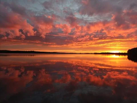 Mirror calm lake at sunset Stock Photos