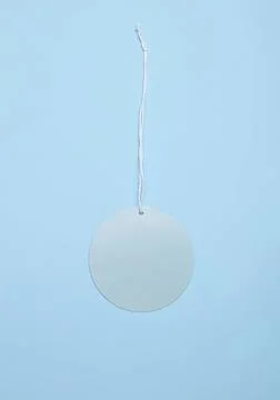 Mirror circle hanging on string against blue background Stock Photos