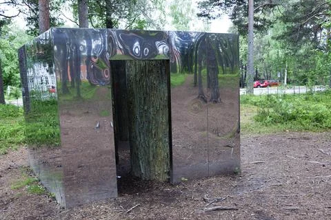 A mirror cube in the forest as an art project Stock Photos
