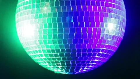 Mirror disco ball on a black background in the light of blue and green Stock Footage 100370533