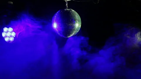 Mirror disco ball on a black background in the rays of working lighting and 스톡 동영상 100681151