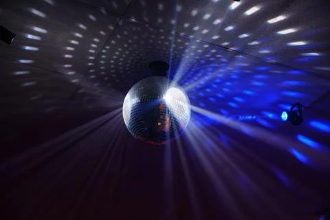 Mirror disco ball with blue light rays Stock Photos