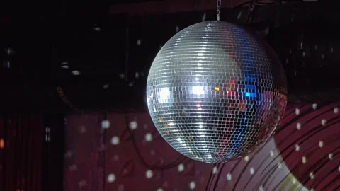 Mirror disco ball spinning on the ceiling of the dance floor Stock Footage 296490936