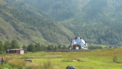 Mirror dome flower structure in green mountain valley at daytime. Stock Footage 315902372