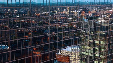 Mirror facade of modern high-rise reflecting the cityscape. Drone footage at the Stock Footage 340477139