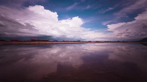 Mirror image cloud reflections on the salt fields of the south east Asia Stock Footage 79314867