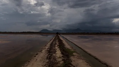 Mirror image cloud reflections on the salt fields of the south east Asia Stock Footage 79314873