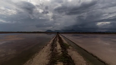 Mirror image cloud reflections on the salt fields of the south east Asia Stock Footage 79314891