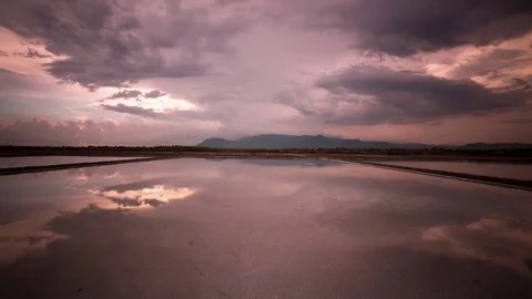 Mirror image cloud reflections on the salt fields of the south east Asia Stock Footage 79314894