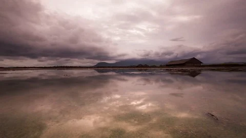 Mirror image cloud reflections on the salt fields of the south east Asia Stock Footage 79314906