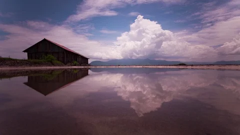 Mirror image cloud reflections on the salt fields of the south east Asia Stock Footage 79314921