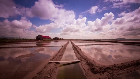 Mirror image cloud reflections on the salt fields of the south east Asia Stock Footage 79314932