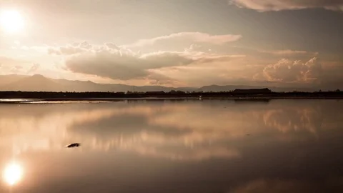 Mirror image cloud reflections at sunset on the salt fields of the south east Stock Footage 79314937