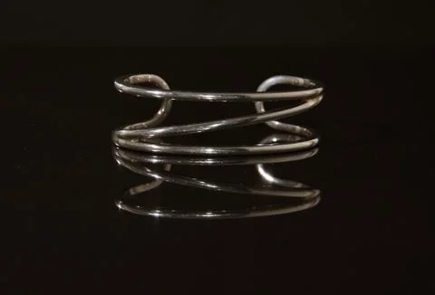 Mirror image of silver bangle Stock Photos