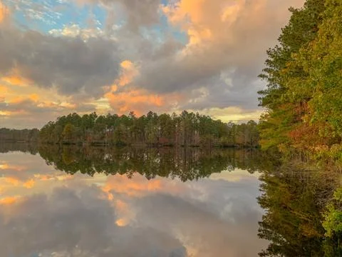 Mirror Lake reflection in fall with trees and clouds Stock Photos