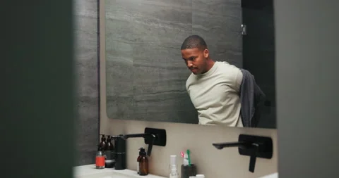Mirror, man and take off robe for grooming, morning routine and walking in Stock Footage 337505896