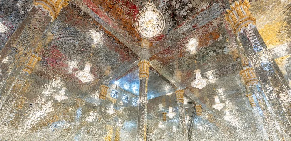 Mirror mosaic ceiling inside a temple with multiple light fixtures creating.. Stock Photos