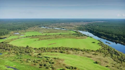 Mirror of Nature, Calm Riverbed Reflecting Sky Amidst Green Summer Fields Stock Footage 257783882
