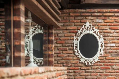 The mirror on the old brick wall Stock Photos