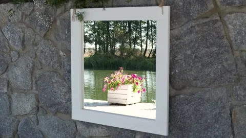 Mirror painting on a stone wall with reflection of a decorative flower Stock Footage 274062969