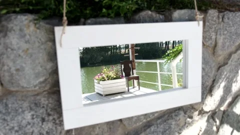Mirror painting on a stone wall with reflection of a decorative flower vase. Stock Footage 274063143