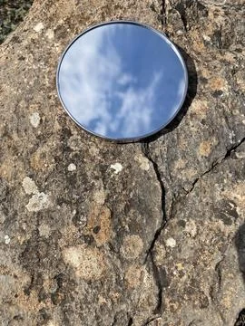 Mirror reflection blue sky on textured stone background Stock Photos