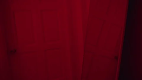 Mirror Reflection of Closed Interior Door Under Red Light Creating Eerie Hallowe Stock Footage 339197812