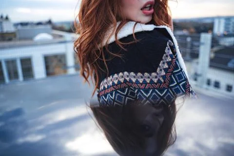 Mirror reflection of female model face looking to camera. Beautiful red haired Stock Photos