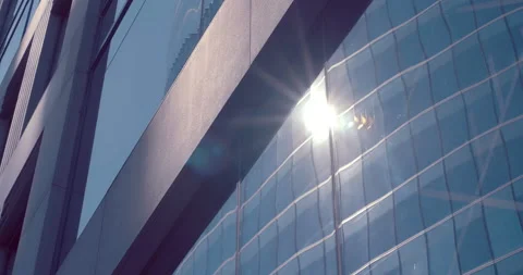 Mirror reflection in the glass surface of a skyscraper, neighboring buildings Stock Footage 119616448