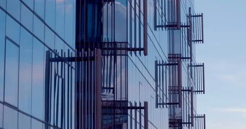 Mirror reflection in the glass surface of a skyscraper blue sky with clouds Stock Footage 119617517