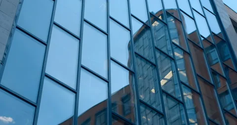 Mirror reflection in the glass surface of a skyscraper, neighboring buildings Stock Footage 119618155