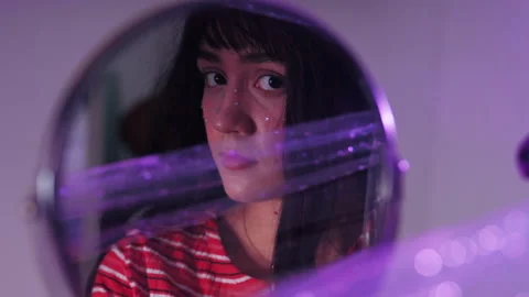 Mirror Reflection Of A Grumpy Woman's Face With Eyes Leering. close up Stock Footage 220471085