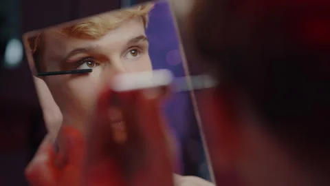 Mirror reflection of a handsome attractive young non binary guy applying Stock Footage 242863797