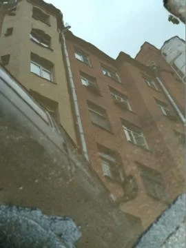 Mirror reflection of a house from a puddle in the rain Foto stock
