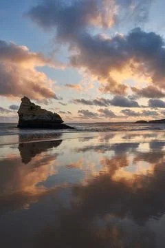 Mirror-like reflection of the limestone rock in the low tide ocean water in P Stock Photos