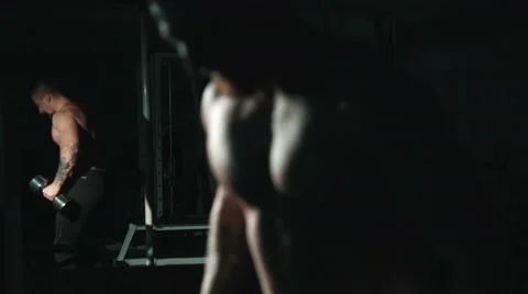 Mirror reflection of Muscle man , workout with weights. Biceps curls exercises. Video stock 68414670