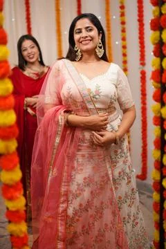 Mirror reflection of two women posing for the camera on the occasion of Diwal... Stock Photos