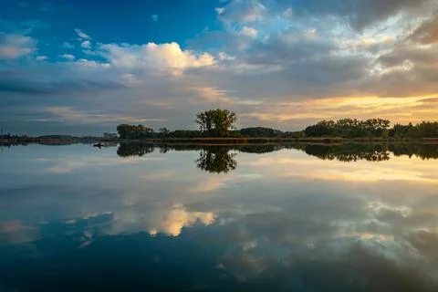 Mirror reflection in the water of evening clouds Stock Photos