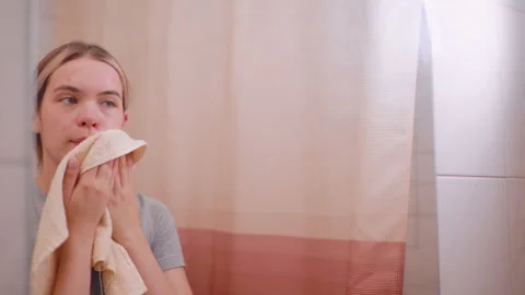 Mirror Reflection Of Woman Using Towel To Clean Face After Washing Stock Footage 321428440
