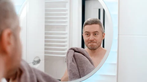 Mirror reflection young happy man wiping hand with towel Video stock 244490902