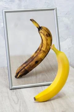 The mirror reflects a spoiled banana. Stock Photos